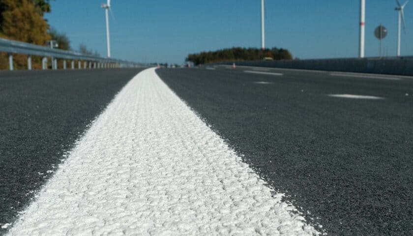 Debela bela oznaka na asfaltu koja prikazuje horizontalnu signalizaciju na putu.